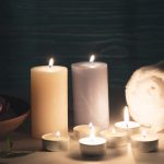 wax-illuminated-candles-with-spa-wellness-setting-table