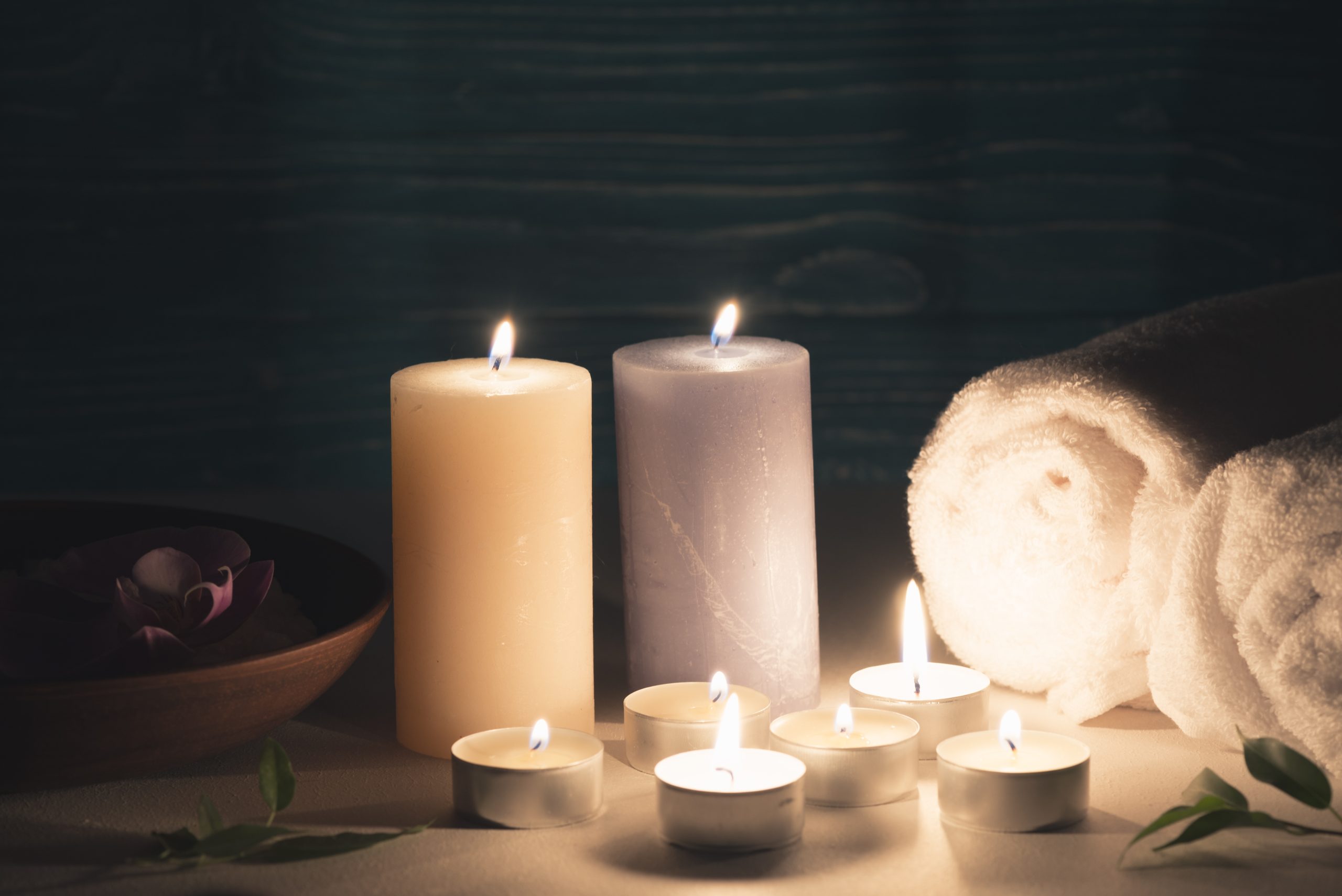 wax-illuminated-candles-with-spa-wellness-setting-table